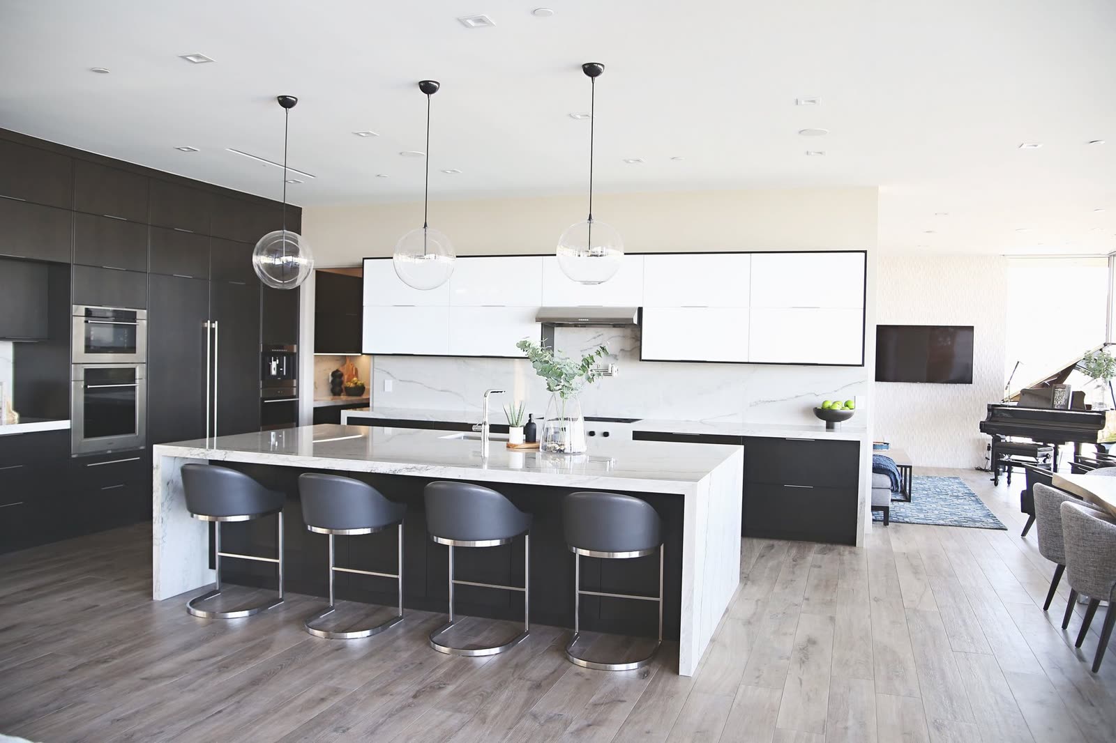 Custom kitchen with a full-length island and integrated appliances