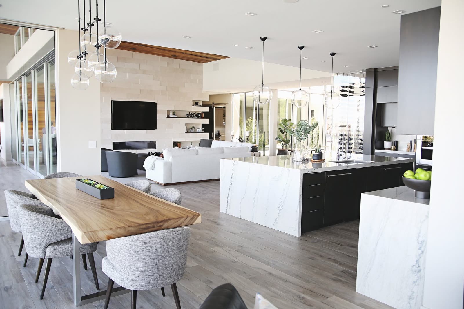 Dining and living space opening onto the desert through glass walls