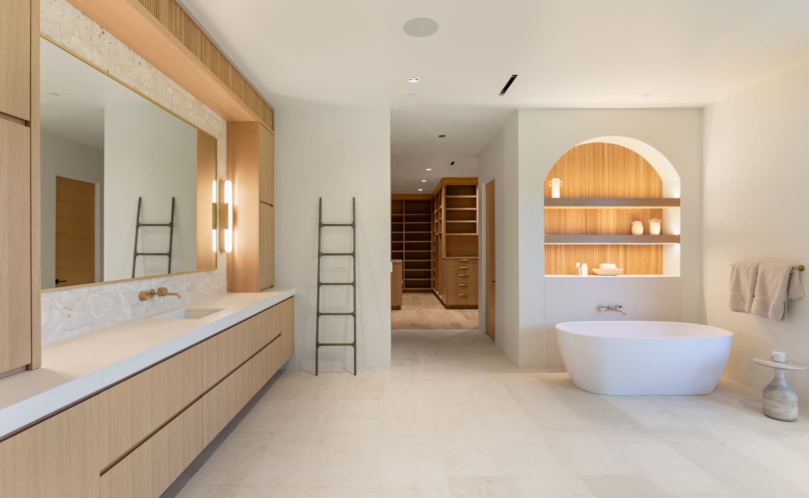 Primary bathroom with a freestanding tub and an arched niche