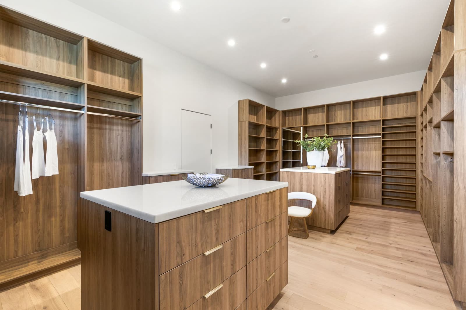 Walk-in dressing room finished in warm timber joinery